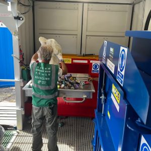 Green Man staff using the can baler